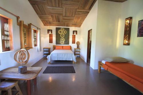 a bedroom with a bed and a table in a room at Pousada Maresia in Atins