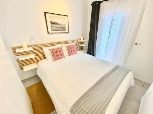 a bedroom with a large bed with a window at MonKeys Apartments Los Viajantes in Seville