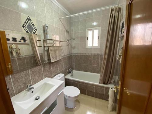a bathroom with a sink and a toilet and a tub at Bungalow Alberca La Nucia in Polop