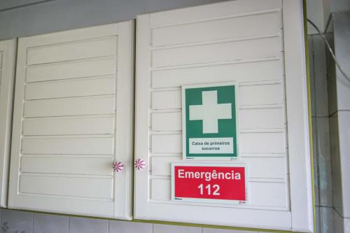a window with a sign that reads emergency at Enjoy Lisbon Cascais Sintra 1200 metres to metro blue line Sintra Rail line Free Parking in Amadora