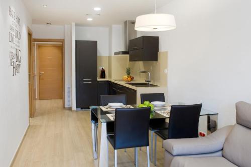 a kitchen and dining room with a table and chairs at Home to Home Barcelona in Barcelona
