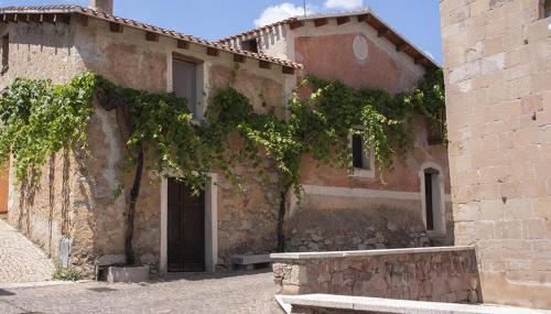 a brick building with a bench in front of it at Holiday Mandrolisai DOC in Atzara