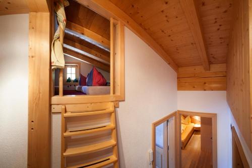a tiny house with a bedroom and a bunk bed at Haus Patricia in Kartitsch
