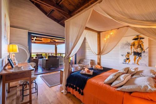 a bedroom with a bed with pillows on it at KAZ PASSION - Villa Haut de gamme in Rivière