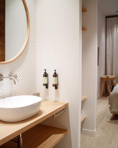 a bathroom with a white sink and a mirror at Casa du Soleil Hostal Boutique in Madrid