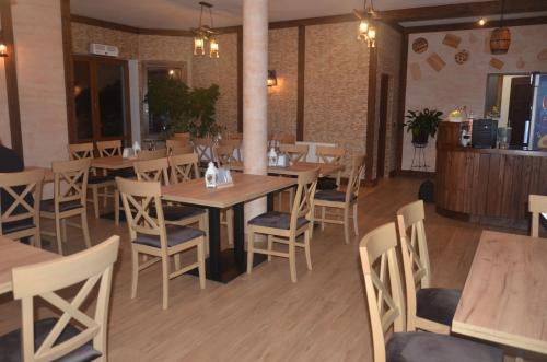 a dining room with wooden tables and chairs at Noclegi Avoca in Pyrzowice
