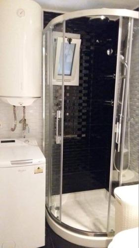 a shower with a glass door in a bathroom at SANTA SUSANNA Sea Dreams Appartement - Bord de mer in Malgrat de Mar