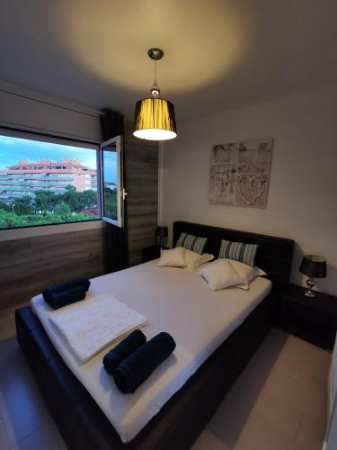a bedroom with a large bed with a large window at SANTA SUSANNA Sea Dreams Appartement - Bord de mer in Malgrat de Mar