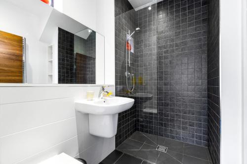 a white bathroom with a sink and a mirror at 1 Beachdown in Bigbury