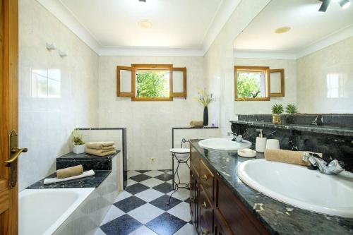 a bathroom with two sinks and two mirrors at NEW! Villa Orquidea - walking distance to Pollença village in Pollença
