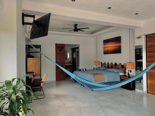 a bedroom with a bed and a hammock at Casa Makawe ONLY ADULTS in Sayulita