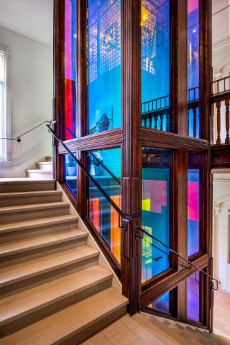 a staircase in a building with stained glass windows at Gladstone House in Toronto