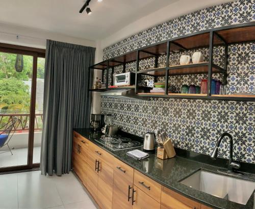 a kitchen with a sink and a counter top at Casa Makawe ONLY ADULTS in Sayulita