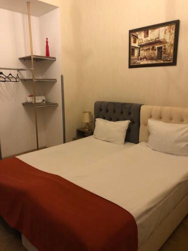 a bedroom with a large bed with white sheets and pillows at Brickwall Tbilisi-Tbilisi vibe in Tbilisi City