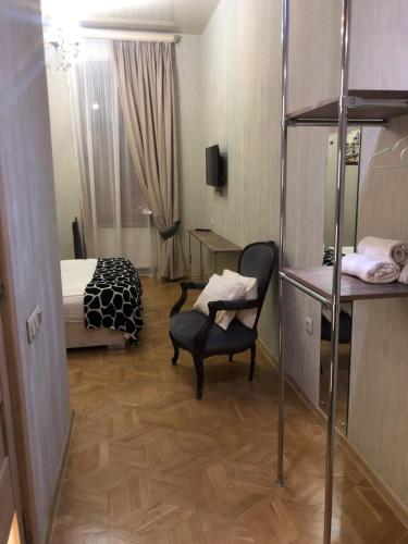 a bedroom with a bunk bed and a chair and a desk at Brickwall Tbilisi-Tbilisi vibe in Tbilisi City