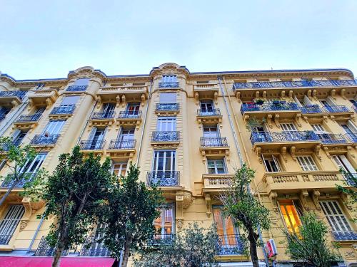 a large building with balconies and trees in front of it at Nestor&Jeeves - MODERN ROCK - Central - Very close sea in Nice