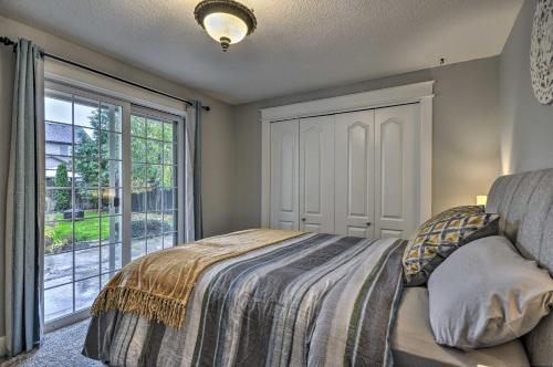 a bedroom with a bed and a large window at Chic Battle Ground Apartment about 18 Mi to Vancouver! in Battle Ground