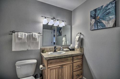 a bathroom with a sink and a toilet and a mirror at Chic Battle Ground Apartment about 18 Mi to Vancouver! in Battle Ground