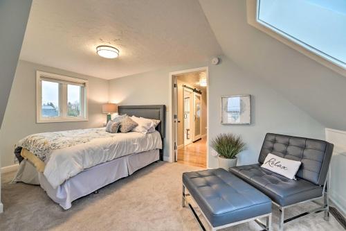 a bedroom with a bed and a chair at Chic Manistee Cottage Steps to Lake Michigan! in Manistee