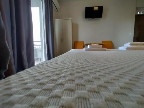 a large bed in a room with a window at Peania Domus in Paianía