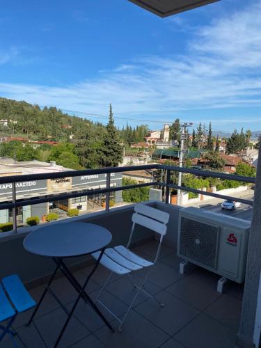 a balcony with a table and chairs and a view at Peania Domus in Paianía