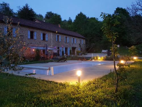 a house with a swimming pool at night at Gites de La Soulière in Aubin
