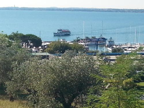a boat is docked at a marina on the water at Relais Rosa Dei Venti -Ciao Vacanze- in Moniga