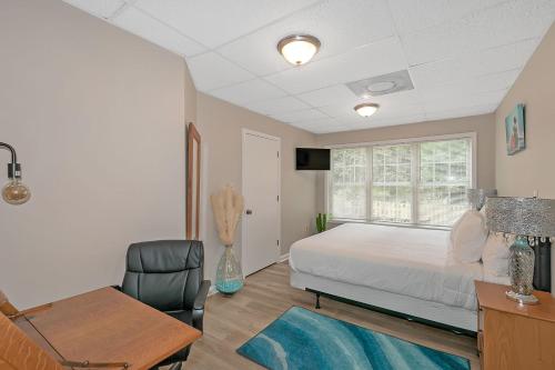 a bedroom with a bed and a desk and a chair at Nature Lover Minimalist APT In Tranquil Cul De Sac in Decatur