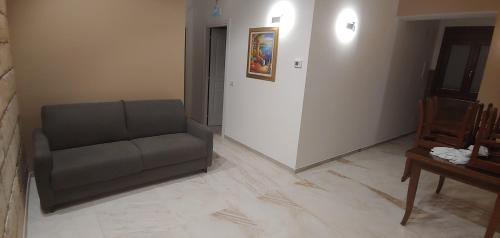 a living room with a couch and a table at La Piana Hotel in Tito