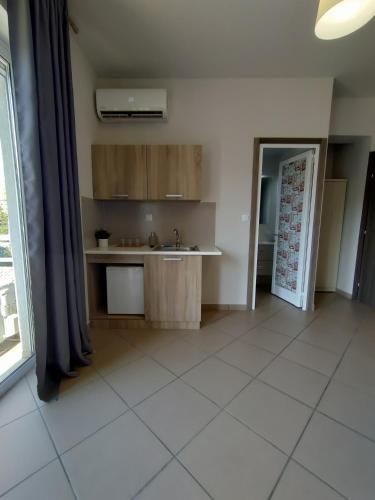 a kitchen with a sink and a counter in a room at Peania Domus in Paianía