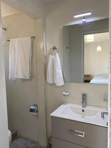 a bathroom with a sink and a mirror at Peania Domus in Paianía