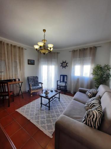 a living room with a couch and a table at CASA DO NINHO - Entre o Campo e a Praia in Cadaval