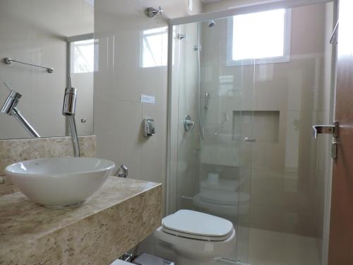 a bathroom with a sink and a toilet and a shower at Beira Mar Village in Pinheira