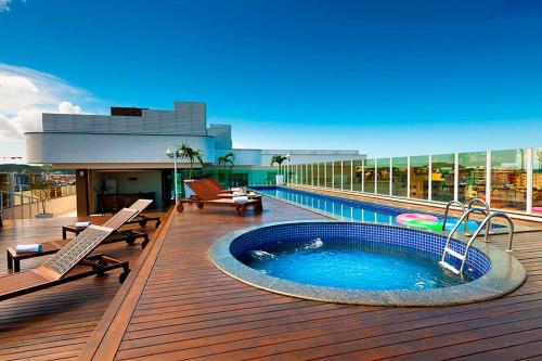 a hot tub on the deck of a building at Oasis Cabo Frio in Cabo Frio