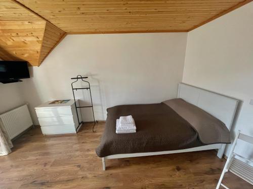 a bedroom with a bed and a wooden ceiling at Yaremche House in Yaremche