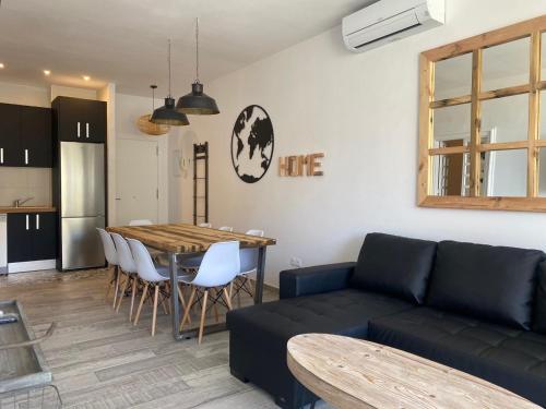 a living room with a couch and a table at Puerto Marina in Benalmádena