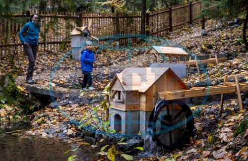 a child standing next to a toy house in the water at Apartmán Frank in Česká Kamenice