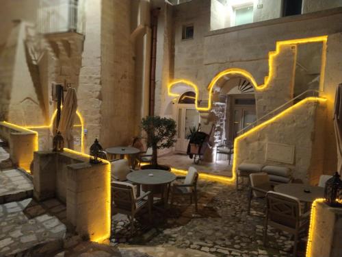 a courtyard with tables and chairs in a building with lights at LA DIMORA DELLE 3 ZIE in Matera