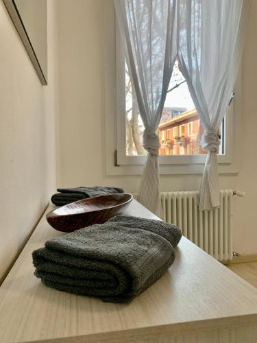 a group of towels sitting on a table with a window at Casa Milena in Mestre