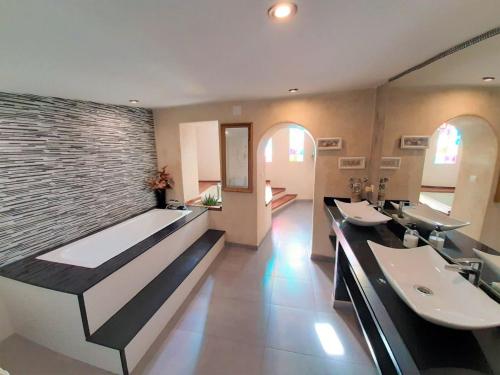 Łazienka z 2 umywalkami i ceglaną ścianą w obiekcie LA CASA DE LA PINTORA DE CAZORLA,ideal para familias y grupos grandes w mieście Cazorla
