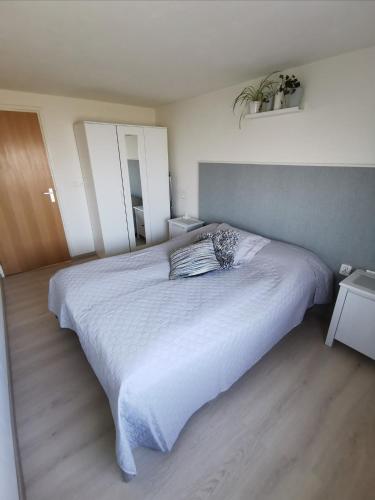 een slaapkamer met een groot wit bed. bij ’t Appelke - Hof van Libeek in het heuvelland in Sint Geertruid