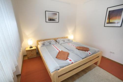a bed in a room with two towels on it at Apartment-76 in Wallern im Burgenland