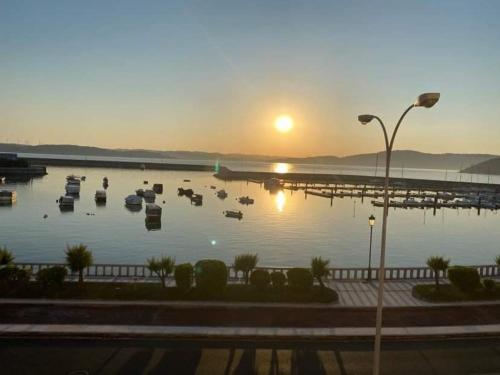 a view of a marina with boats in the water at Pousadas Mariñeiras,sl - AT "Camiño da Barca" in Muxia