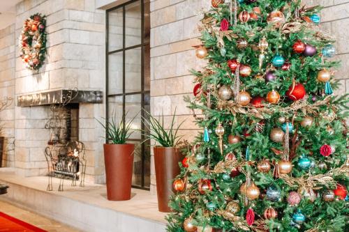 a christmas tree in front of a fireplace at Omni Fort Worth Hotel in Fort Worth