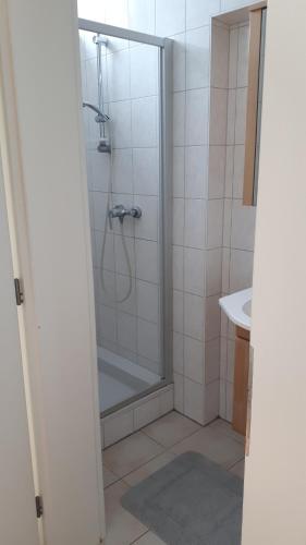 a bathroom with a shower and a sink at City Appartment Orlitsch in Klagenfurt