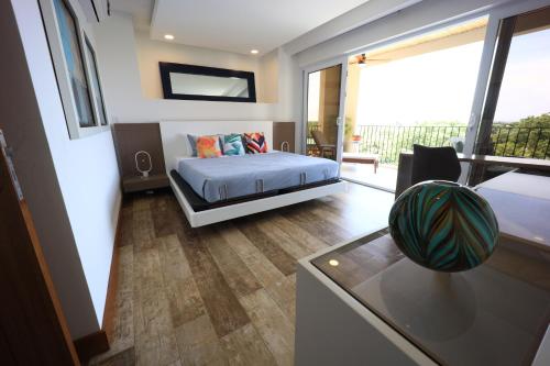 a bedroom with a bed and a large window at Brandnew Luxury 2Bdr condo✰Stunning view✰Fast wifi in Tamarindo
