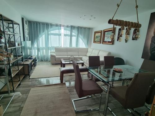 a living room with a couch and a table at Chalet Adosado Urbanización COPOS PREMIUM Zona Media in Sierra Nevada