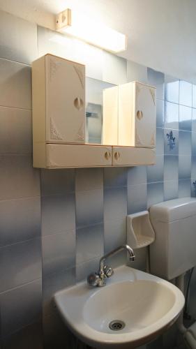 a bathroom with a sink and a mirror at Dimitra Apartments in Kandia