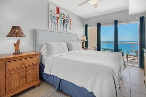 a bedroom with a bed and a view of the ocean at Emerald Isle unit 1206 in Pensacola Beach