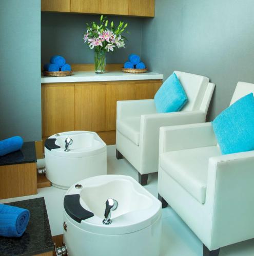 a bathroom with two sinks and two toilets at Radisson Blu Hotel Guwahati in Guwahati